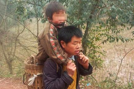 Dad treks 29 km to and from son's school every day, carrying him on his back