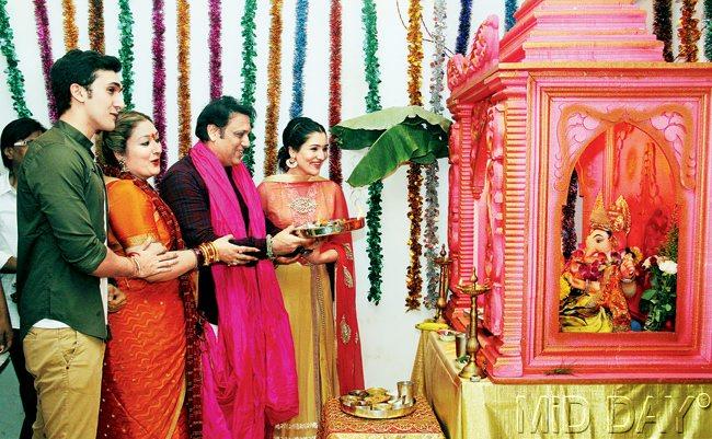 Govinda with wife, Sunita, son, Yashvardan and daughter, Narmada perform the aarti at their Juhu residence