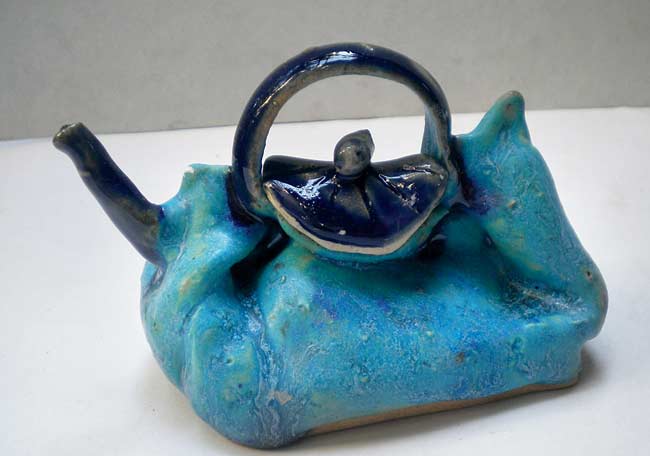 Kettle purse by Shalan Dere; (below)  Ceramic angels and dolls 