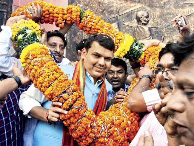 Chief Minister Devendra Fadnavis is welcomed on his arrival at Nagpur on Sunday, where he spoke about the institution. Pic/PTI