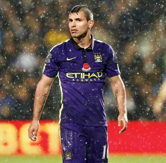 Sergio Aguero gets drenched in the rains during Man City