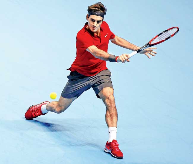 Roger Federer returns to Kei Nishikori during their World Tour Finals clash in London yesterday. Pic/AFP