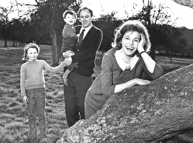 American actor Patricia Neal smiles with her husband, Welsh-born author Roald Dahl and two of their children outside their farmhouse. 