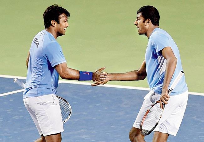 Leander Paes (left) and Rohan Bopanna celebrate a point against Serbia