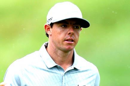 Golfer Rory McIlroy hits ball into spectator's pocket