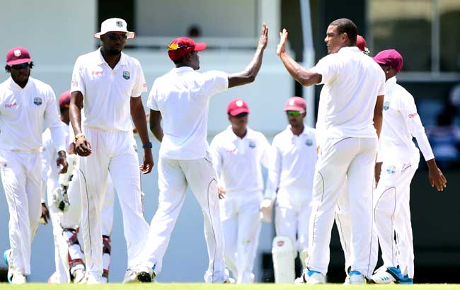 West Indies Jerome Taylor L high-fives bowler Shannon Gabriel R after his delivery to Shaiful Islam of Bangladesh was caught by wicket keeper Danesh Ramdin for an out on day three of the second and final Test between West Indies and Bangladesh in Gros Islet, St Lucia. Pic/AFP