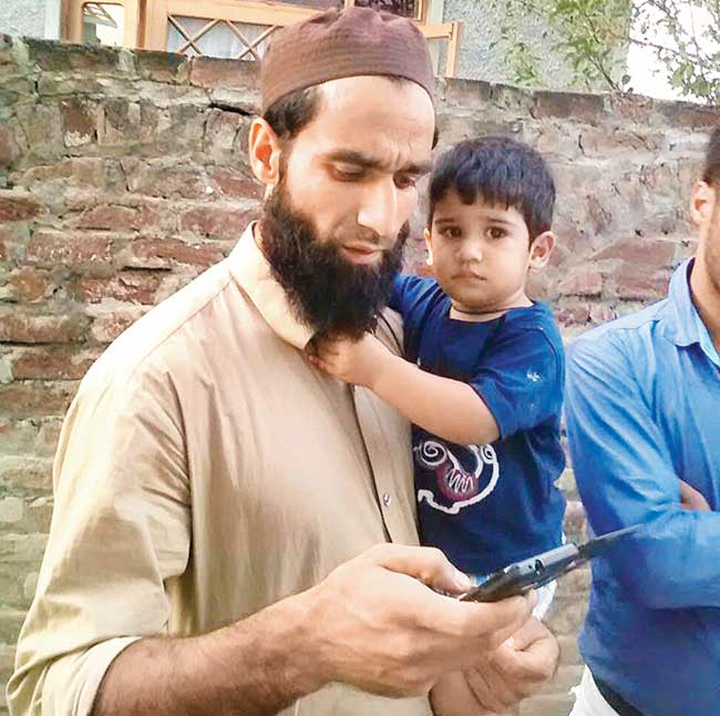 A file picture of Mehrajuddin Wadoo with his son Mohammad Ahmad
