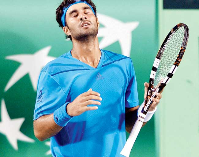 Yuki Bhambri reacts after losing a point to Serbia