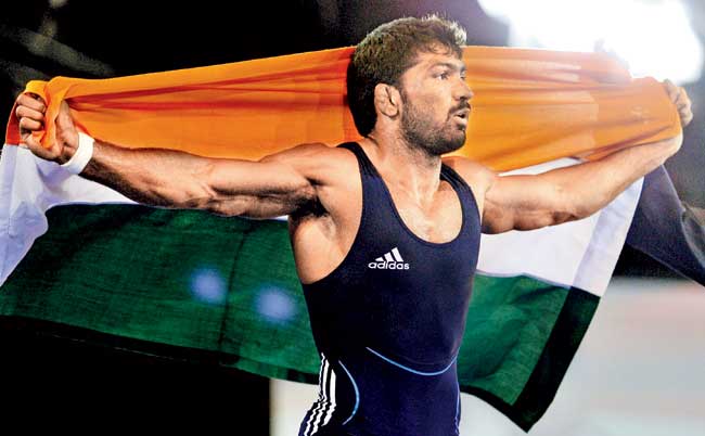 Yogeshwar Dutt celebrates after clinching the gold medal match at the Glasgow Commonwealth Games. Pic/AFP