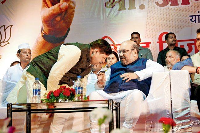 For your ears only: BJP chief Amit Shah and MLA Girish Bapat share a few quiet words during the party workers’ gathering, titled ‘Vijay Sankalpa Melava’. pics/Shashank Sane