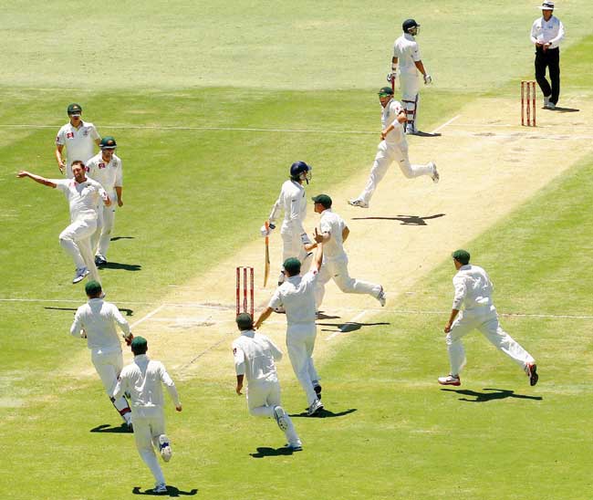 Australian pacer Ben Hilfenhaus (left) celebrates the wicket of India