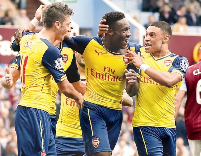 Danny Welbeck (centre) celebrates with teammates after scoring at Villa Park. Pic/AFP