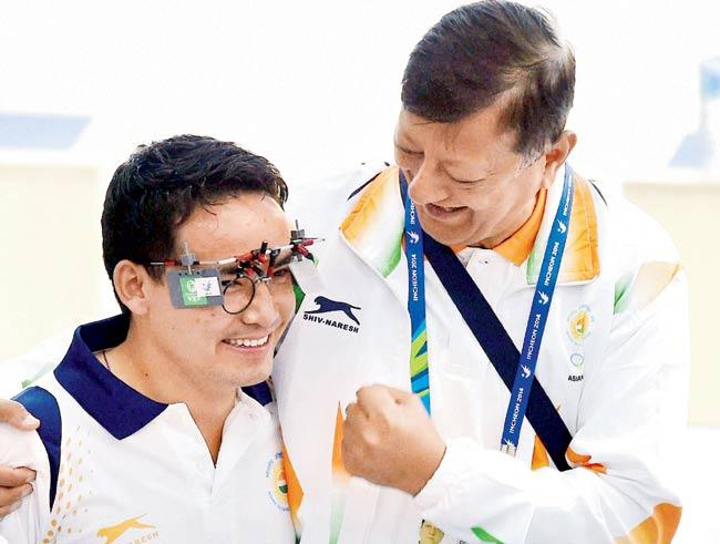 Jitu Rai (left) is greeted by his coach after winning the 50m Air Pistol gold at the Asian Games in Incheon on Saturday. Pic/PTI