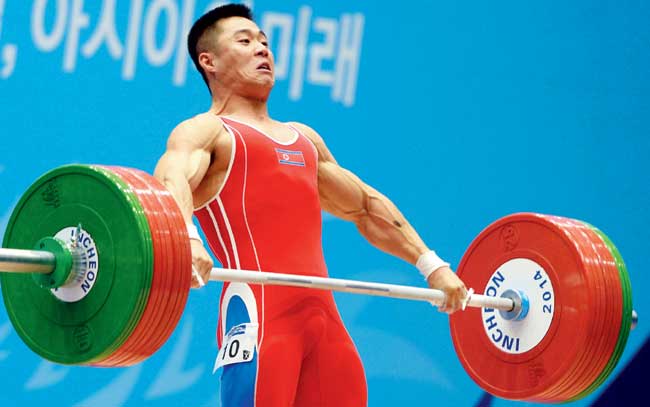 Kim Un-Guk competes in the 62kg weightlifting event. Pic/AFP