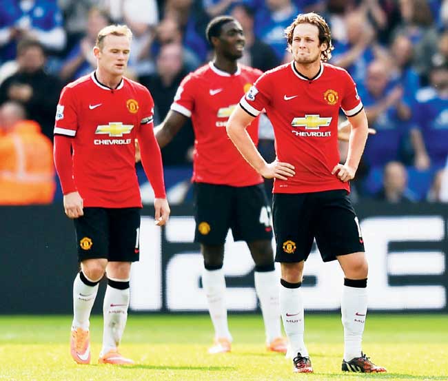 Red-faced: Manchester United skipper Wayne Rooney (left) alongwith teammates Tyler Blackett and Daley Blind (right) seem stunned after their 3-5 defeat to Leicester City in the English Premier League yesterday. Pic/Getty Images