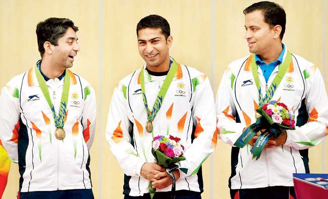 Abhinav Bindra (extreme left), Ravi Kumar and Sanjeev Rajput (right) with their bronze medals during the presentation ceremony yesterday