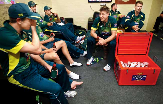 Aussie James Faulkner shares a joke with his teammates in the dressing room yesterday. Pics/Getty Images