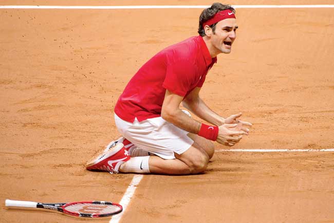Roger Federer exults after beating Richard Gasquet to win the Davis Cup in Lille yesterday. Pic/AFP