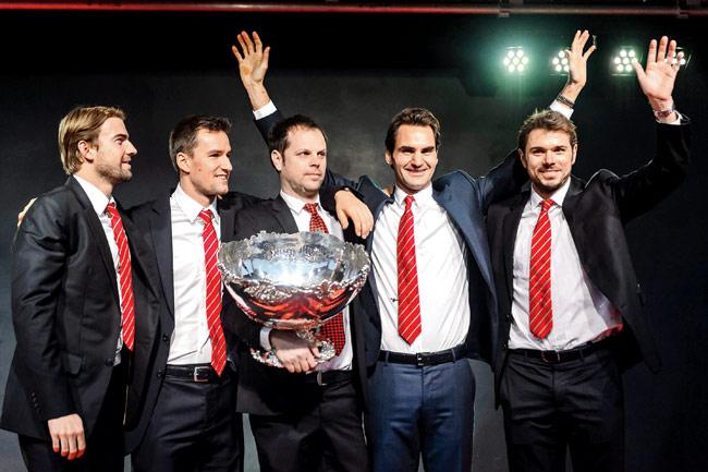 This one’s for the boys: Swiss Davis Cup team (From left) Michael Lammer, Marco Chiudinelli, team captain Severin Luethi, Roger Federer and Stan Wawrinka pose with the Davis Cup trophy in Lausanne. Federer was the toast of Switzerland on November 23, as he applied the final touches to his country’s first ever Davis Cup win. Pic/AFP