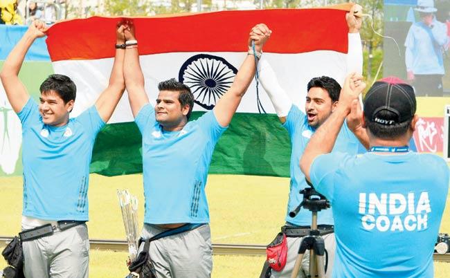 Abhishek Verma (left), Sandeep Kumar and Rajat Chauhan (right) celebrate their gold-medal winning performance in Incheon. Pic/PTI