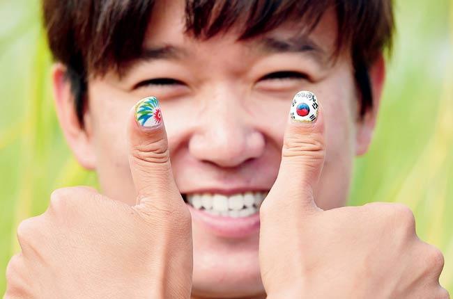 Chung Jeong-Seok shows off his nail art. Pic/AFP
