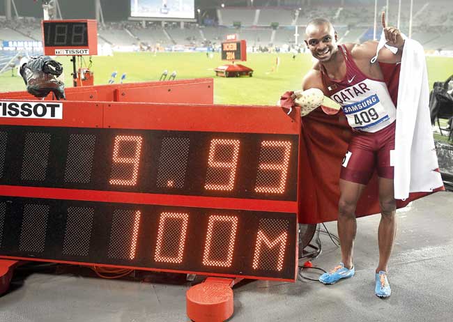 Femi Ogunode poses with the timer showing his new Asian record during the Asian Games