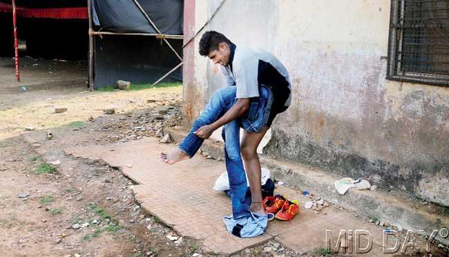 A Guru Nanak player changes after his match at the Anna Bhau Sathe ground. The official 