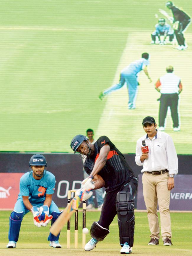 Usain Bolt attempts to hit Yuvraj Singh back over his head during an exhibition match played at the Chinnaswamy Stadium in Bangalore yesterday. Pic/ Bangalore News Photos