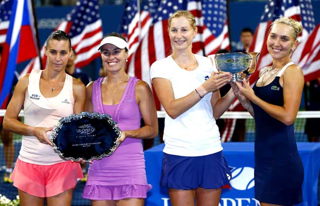 Ekaterina Makarova (2R), Elena Vesnina (R) of Russia, Martina Hingis (2L) of Switzerland and Flavia Pennetta (L) of Italy pose with their trophies after their women