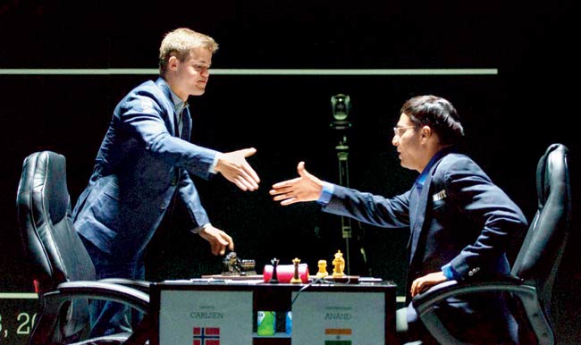 Magnus Carlsen and Viswanathan Anand (right) shake hands before the opening match of the World Chess Championship in Sochi on Saturday. Pic/AP/PTI