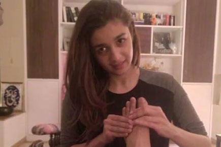 Who is Alia Bhatt giving a massage to?