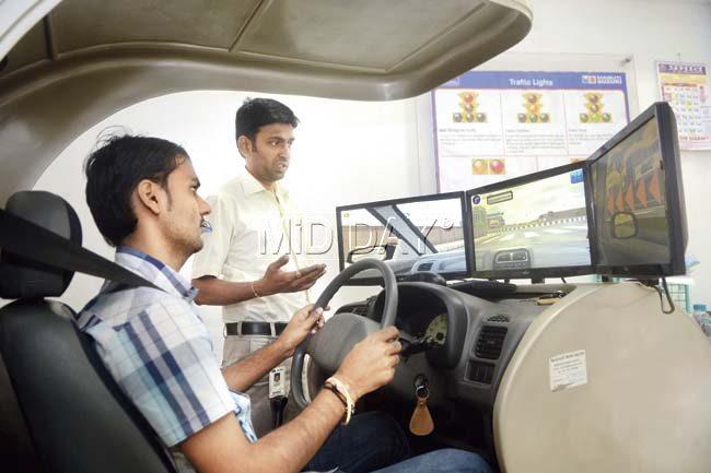 A man learns to drive on the car simulator. Pics/Pradeep Dhivar