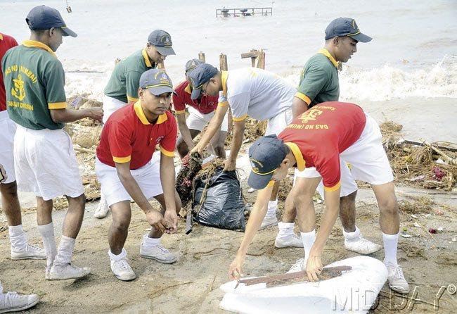 Schoolchildren, NCC cadets and NGO workers pick up the waste and litter left behind by Ganpati devotees at Versova beach and Girgaum Chowpatty. Pic/Deepak Salvi
