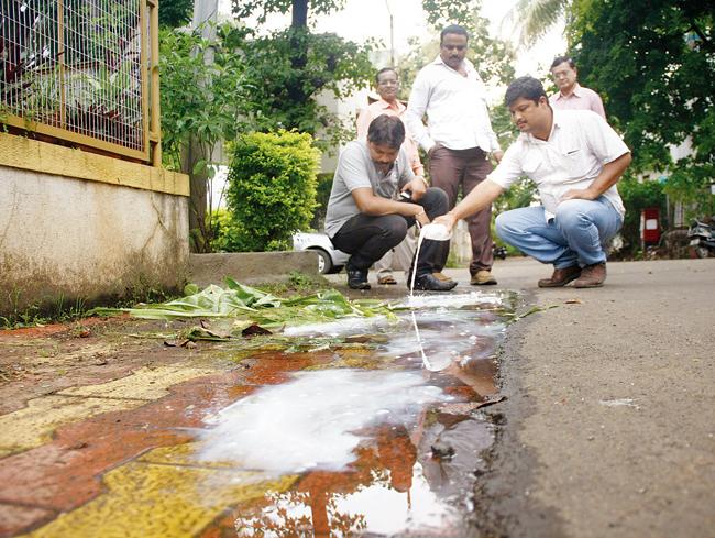 Health officials spray insecticides at Gopal Society in Anand Nagar to prevent breeding of dengue mosquitoes. 