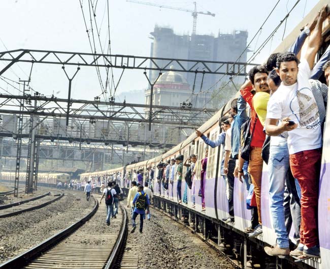 With local trains almost always overcrowded, commuters have been known to fall off mid-journey, leading to several injuries or even death. File pic