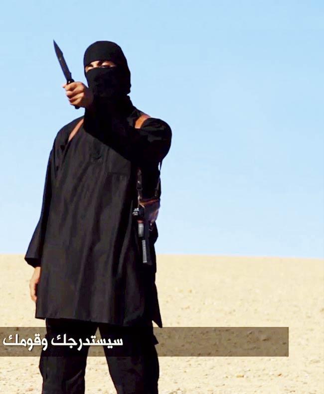 An image grab taken from a video released by the Islamic State (IS) and identified by private terrorism monitor SITE Intelligence Group on September 13, 2014 purportedly shows a masked militant holding a knife and gesturing as he speaks to the camera in a desert landscape before beheading British aid worker David Haines. Pic/AFP
