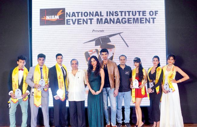 Mr and Ms University winners with the judges 