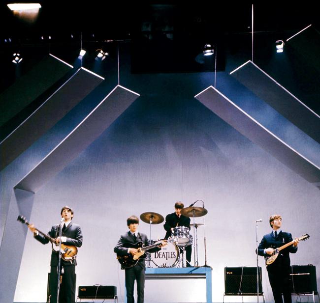 The Beatles (from left to right), Paul McCartney (bass), George Harrison (guitar), Ringo Starr (drums) and John Lennon (guitar) perform on stage during a concert on July 25, 1965, in London. The band named their 11th studio album after the recording studio after which it began to find fame across the globe.