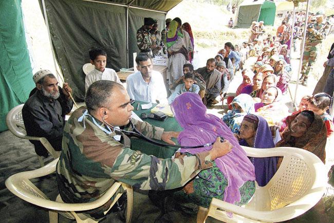 Flood victims at a medical checkup camp organised by Army in Rajouri district of Jammu and Kashmir. Pic/PTI