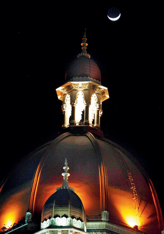 A crescent moon lights up the night sky as the dome of the Taj Mahal Hotel looks resplendent in its regalia. Pic/AFP