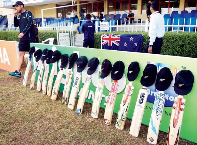 NZ players place their national caps on bats
