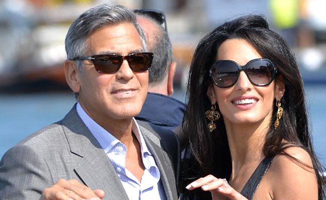 George Clooney with wife Amal. Pic/AFP