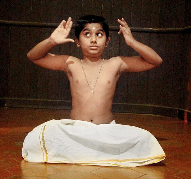 A boy uses movements and gestures to perform Kuttiyattam