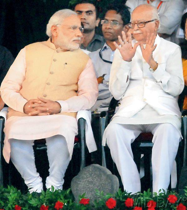 Give peace a chance: LK Advani in an animated coversation with PM Narendra Modi at Wankhede stadium yesterday.