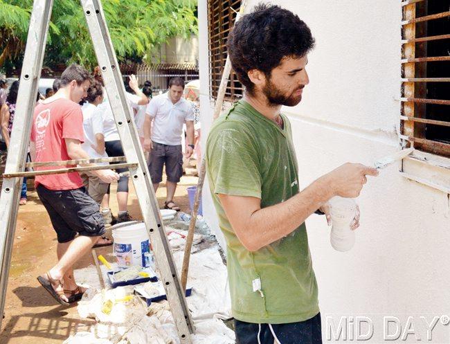 After whitewashing the wall, the municipal school students’ art work will be painted 