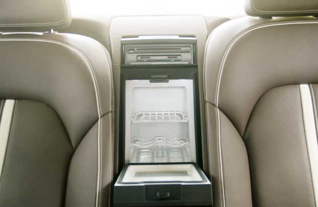 Inside the cabin, there is a small fridge. Notice the CD changer and individual SD card slots above chilled compartment 