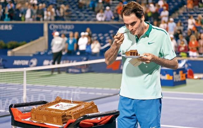 Swiss great Roger Federer has a piece of cake after his quarter-final win over David Ferrer during the Rogers Cup on Friday in Toronto. Pic/AFP