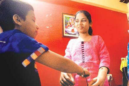 Monika More ties a rakhi using prosthetic arms