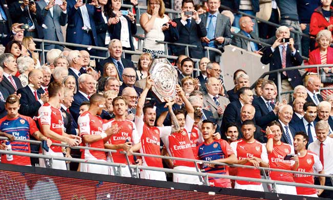 The victorious Arsenal team lift the Community Shield trophy after their 3-0 win over Manchester City at Wembley Stadium yesterday. Pic/AFP
