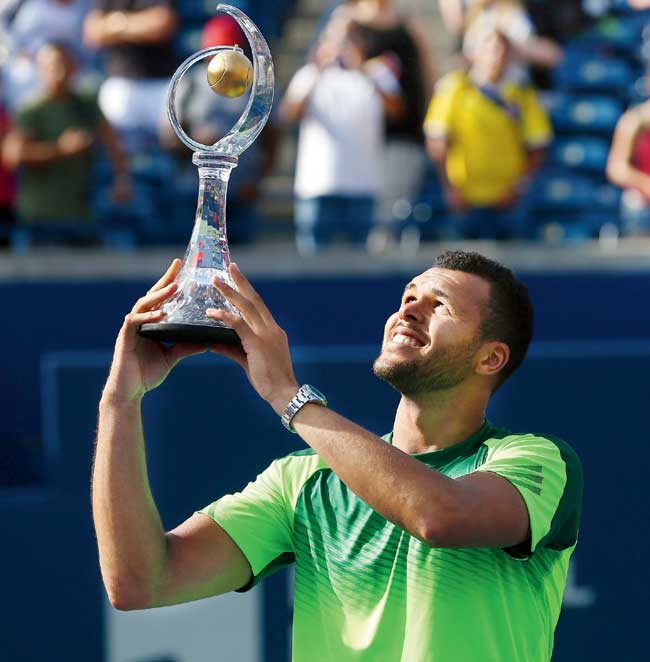 Jo-Wilfried Tsonga holds up the Rogers Cup trophy after beating Roger Federer in Toronto